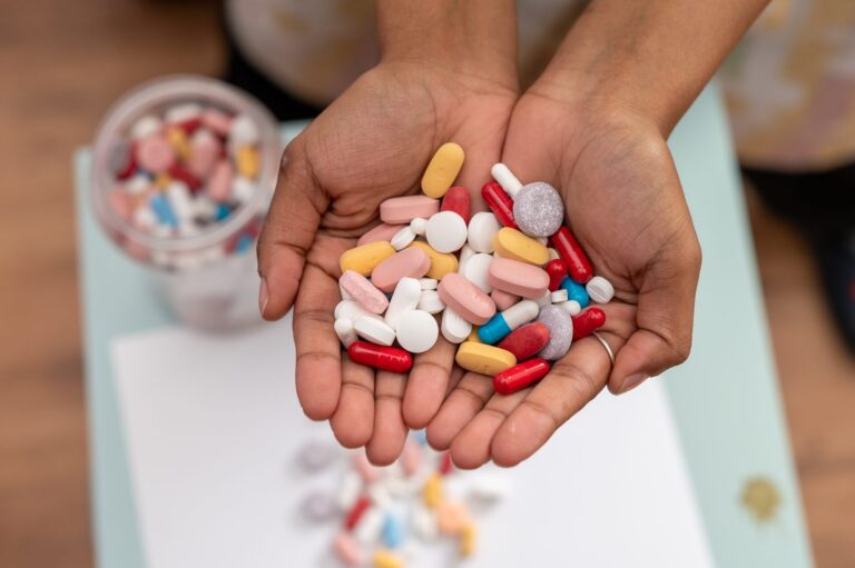 Hands holding medication while considering ADHD treatment and executive function coaching