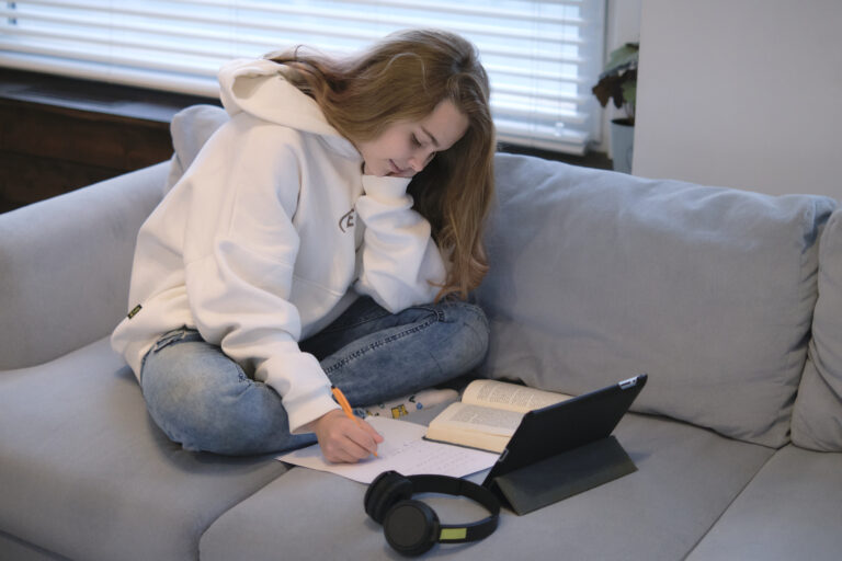 Teen student studying at home with online ADHD coaching and executive function support